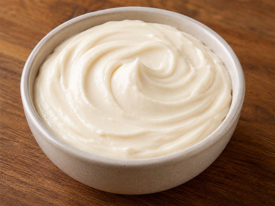 Cup of sweet cream cheese icing dip