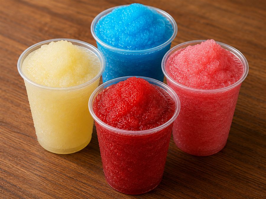 Four colorful slushies in tall cups